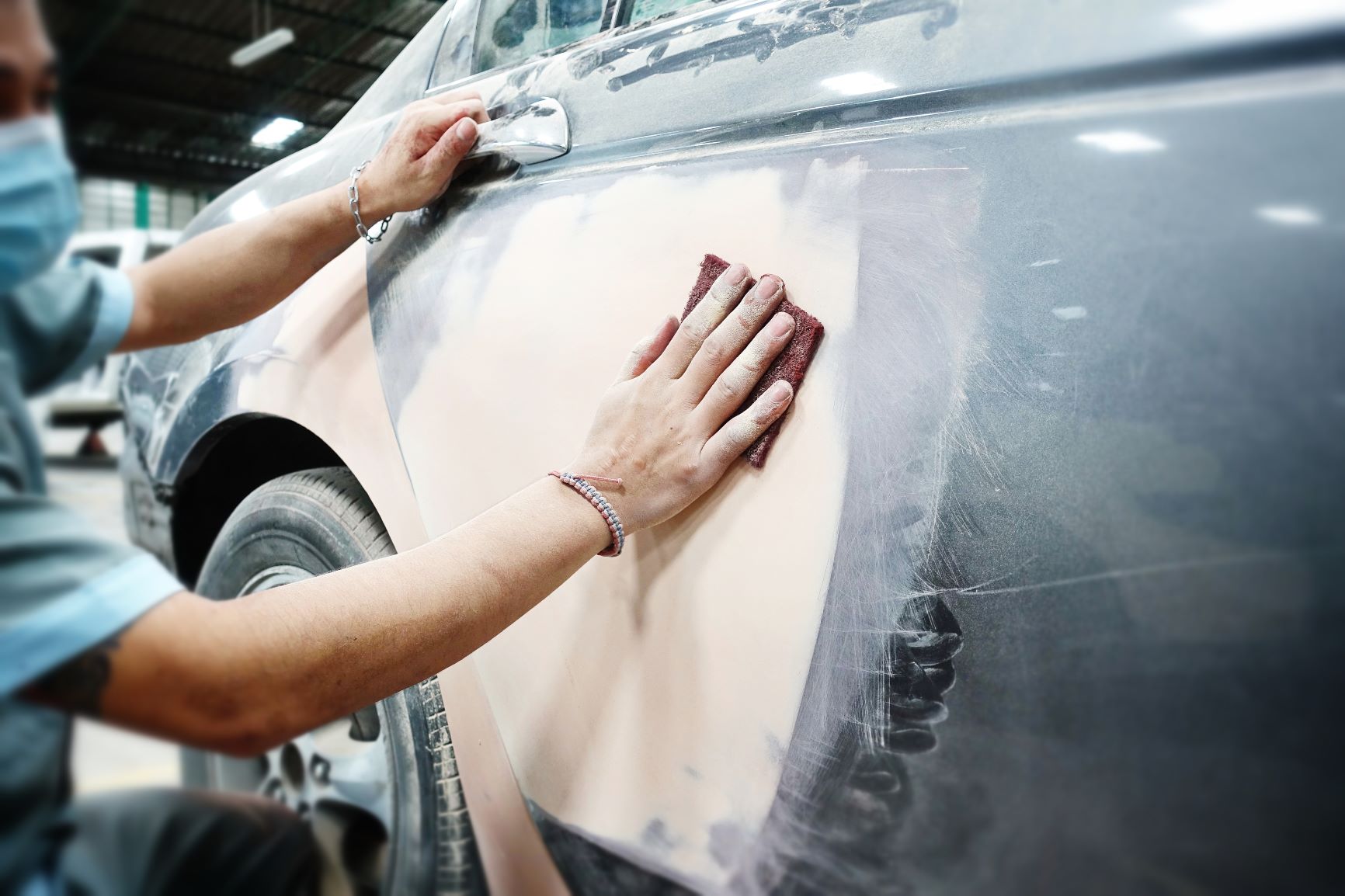 Auto body repair technician working on a vehicle