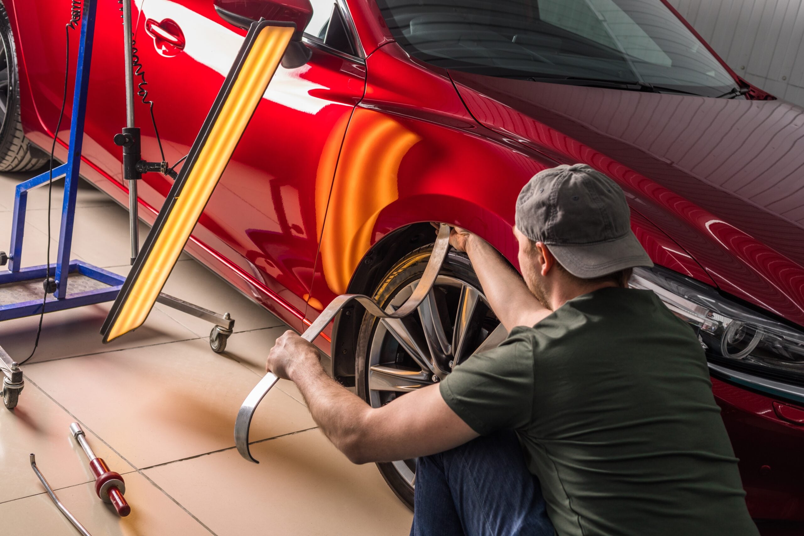 Dent damage on a vehicle being repaired