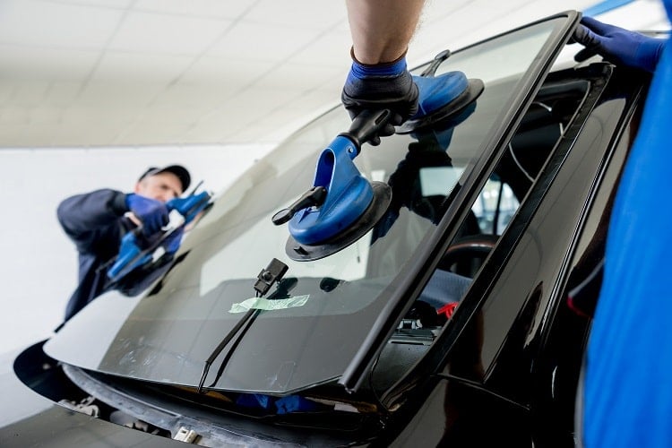 Technician completing auto glass repair